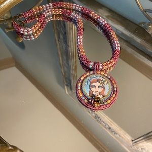 Handmade Painted Lady cabachon with beaded rope.